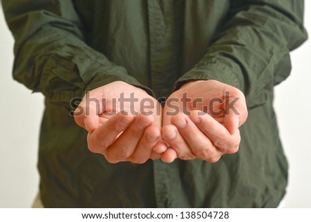 Open hands of a man hopefully held up. Cupped hands asking for something.