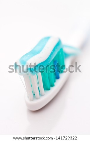 Tooth paste on bush, close up image. Dental hygiene concept.