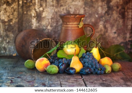 Various fresh autumn fruit: apple on table. Pear, grape, plum, apple and peach.