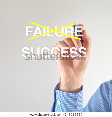 Businessman crosses off Failure for Success with yellow marker pen on the screen