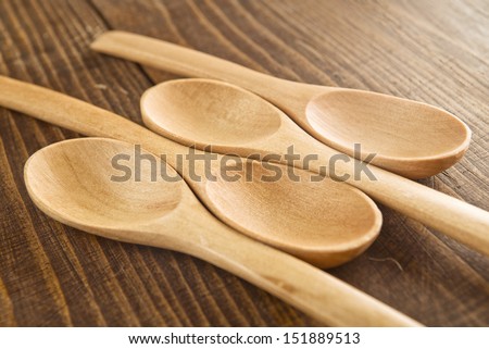 Wood spoons on wooden table. Kitchen utensils.