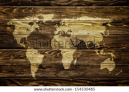 World map on wooden background. Traveling and tourism concept..