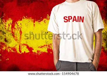 Spanish patriot. Man in white shirt with title SPAIN, Spanish flag in background