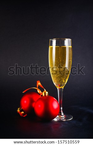 Christmas Balls and glass of white wine. New Year\'s Eve decoration.