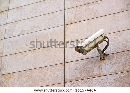 Security camera on the wall. Private property protection.