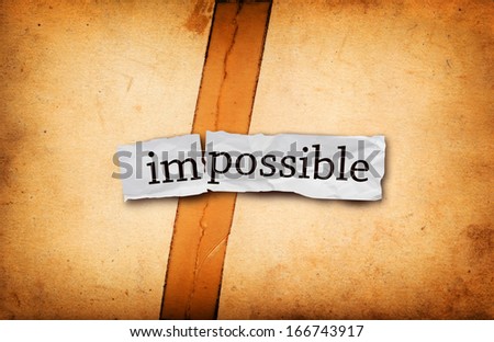Impossible becomes possible. Impossible title on torn paper texture background.