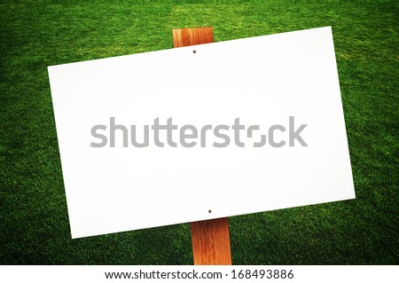 Blank sign on green lawn for your message.