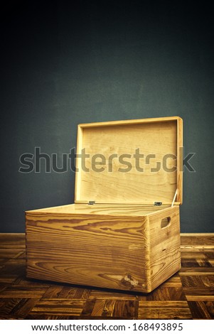 Open Wooden crate box on the floor of the apartment