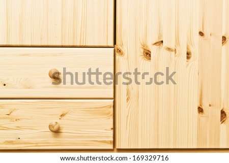 Wooden cabinet drawers with detailed natural wood texture. Home furnishing.
