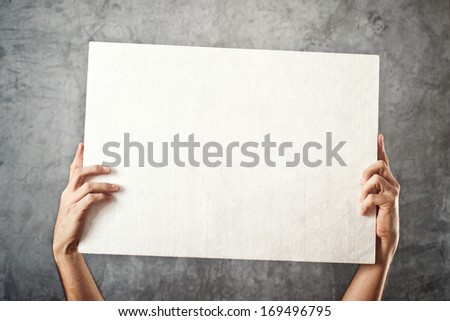 Man holding blank white banner with copy space for your text.