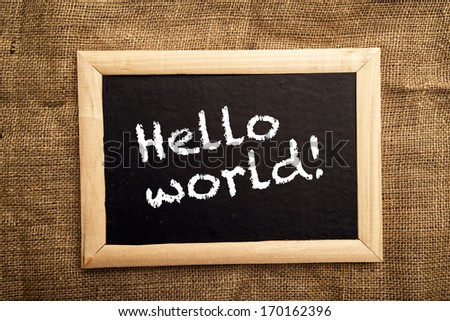 Hello world note on black message board