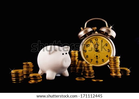 Golden coin stack, piggy coin bank and vintage clock on dark background. Time is money concept.
