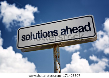 Solution ahead street sign against blue sky with clouds
