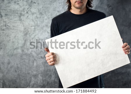 Man holding blank white banner with copy space for your text.