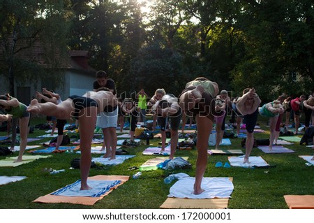 PRAGUE - AUGUST 23, 2012: Group outdoor pilates gathering in park on Kampa island in Prague.