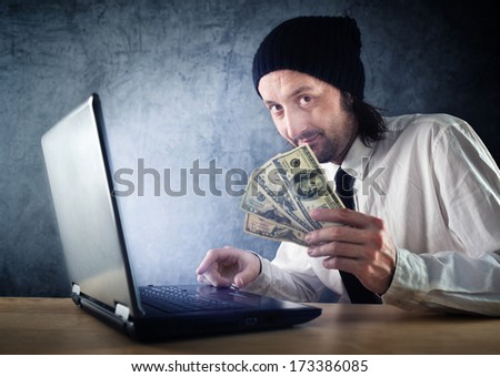 Making money online, businessman with laptop computer is earning money over internet.