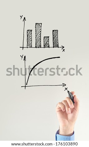 Businessman drawing chart and other infographics in note pad. Close up image with selective focus. Business situation.
