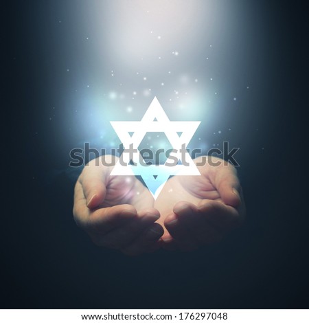 Female hands opening to light and David\'s star. Jewish religion