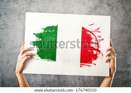 Italy flag. Man holding banner with Italian Flag. Supporting national team, patriotism concept.