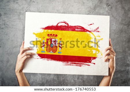 Spain flag. Man holding banner with Spanish Flag. Supporting national team, patriotism concept.