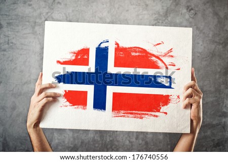 Norway flag. Man holding banner with Norwegian Flag. Supporting national team, patriotism concept.