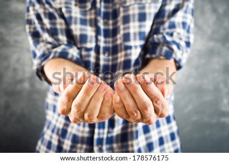 Male open hands for begging hopefully held up. Cupped hands asking for help or charity.