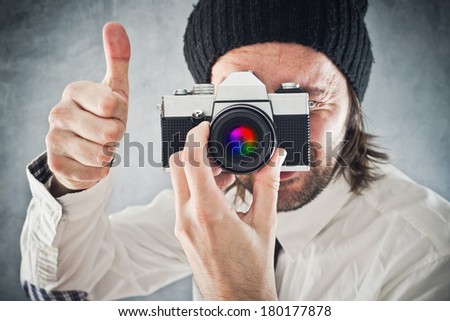 Businessman taking picture with old vintage film photo camera