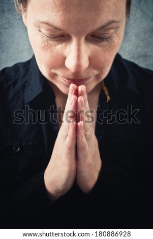 Woman praying and praising the God. Religion, spirituality concept.