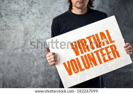 Man holding white banner with VIRTUAL VOLUNTEER title, conceptual image