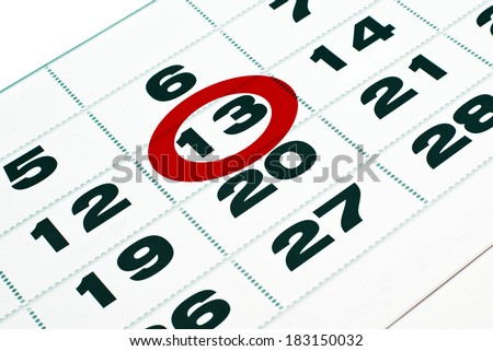 Thirteenth day in calendar, thirteenth day marked in paper calendar laying on the table. Friday the thirteenth.