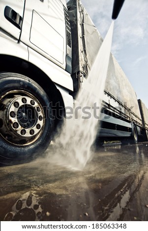 Washing truck service. Commercial transportation vehicle being cleaned.