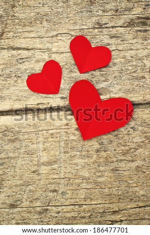 Paper hearts on old wood background. Heart shape red paper note with copy space.