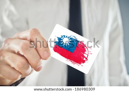 Businessman holding business card with Taiwan Flag. International cooperation, investments, business opportunities concept.