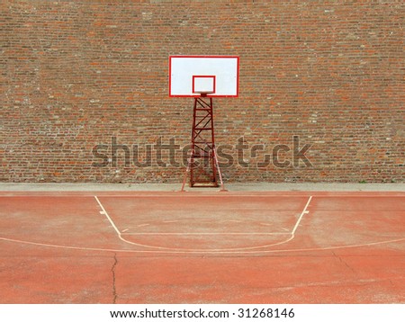 basketball hoop and a cage, red brick wall background.