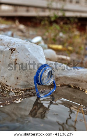 Plastic bottles and other garbage in river, ecology issue.