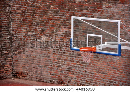 Basketball hoop and an empty outdoor court.