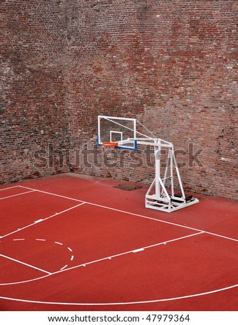 Basketball hoop and an empty outdoor court.