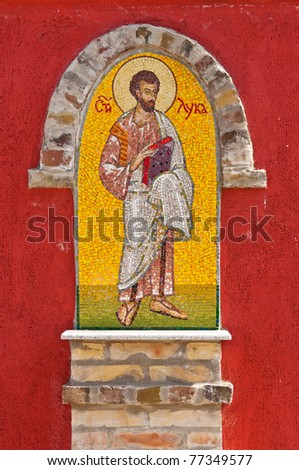 Religious icon on orthodox church wall in Serbia depicting St Luke the Evangelist.