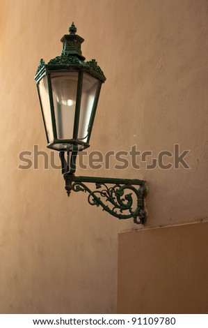 Vintage street lantern on the yellow wall. Image is taken on the streets of Prague, capitol of Czech Republic