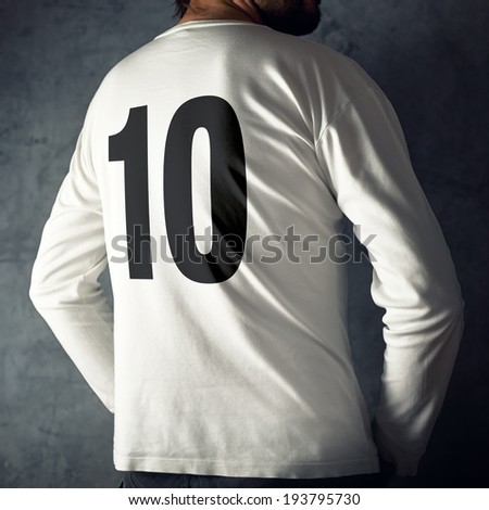 Man wearing sport shirt with number ten printed ion his back.
