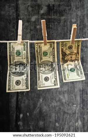American currency. USA money, Dollar bills hanging on rope attached with clothes pins.