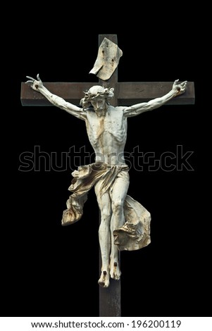 Crucifixion. Christian cross with Jesus Christ statue isolated on black background with clipping work path. Religion and spirituality concept.