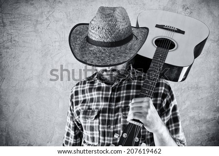 Western country cowboy musician with guitar, black and white portrait.