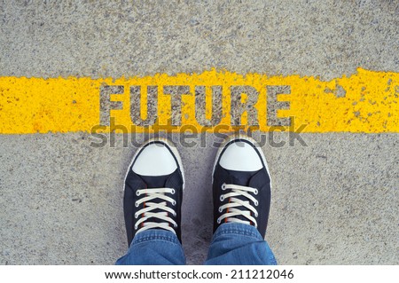 Male sneakers on the asphalt road with yellow line and title Future. Step into the future.