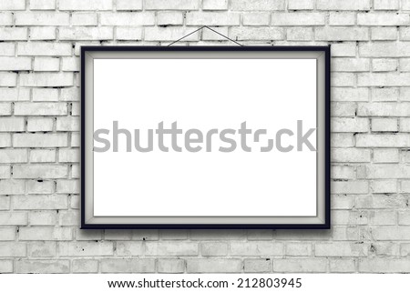 Blank horizontal painting poster in black frame hanging on white brick wall. Painting proportions match international paper size A.