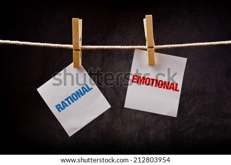 Rational vs Emotional concept. Words printed on note paper and attached to rope with clothes pins.