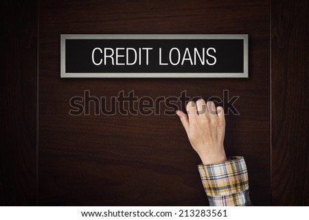 Female hand is knocking on Credit Loans bank department door looking for a service