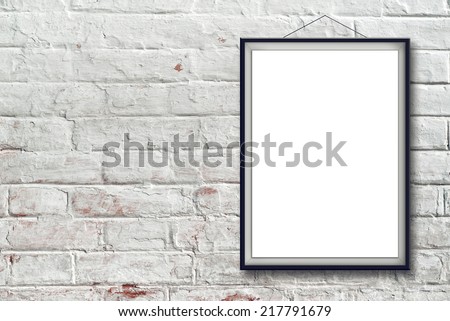 Blank vertical painting poster in black frame hanging on white brick wall. Painting proportions match international paper size A.