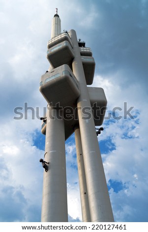 PRAGUE, CZECH REPUBLIC - SEPTEMBER 06, 2014: Famous Prague Zizkov Television Tower with David Cerny\'s sculptures. Tower is an examples of communist-era architecture in Central and Eastern Europe.
