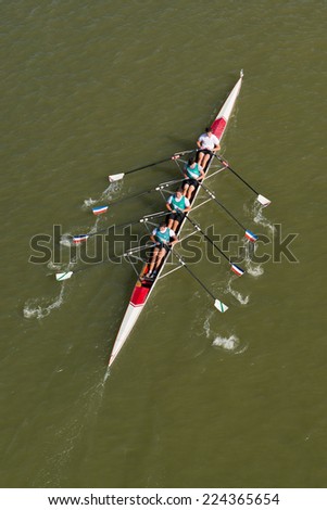 NOVI SAD, SERBIA - OCTOBER 18, 2014: Four men rowing on Danube River in Novi Sad on traditional remote regatta competition.
